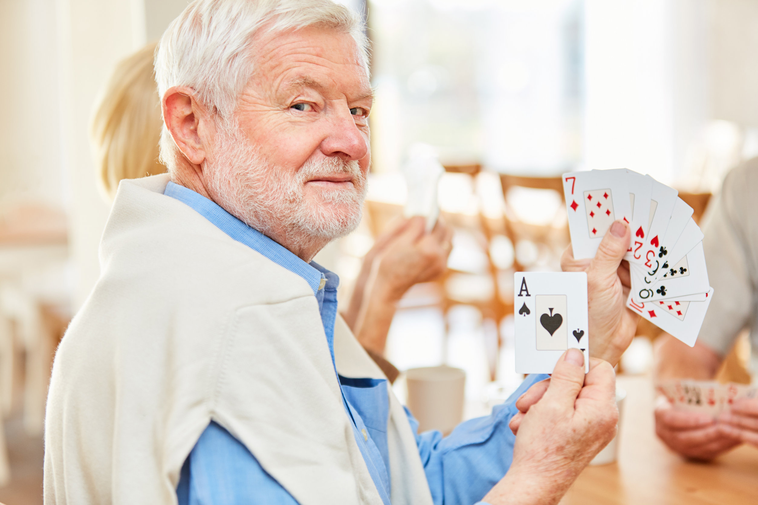 senior man playing cards