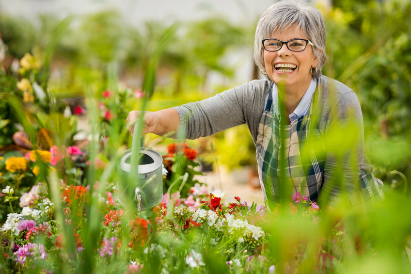 small smiling senior woman in garden