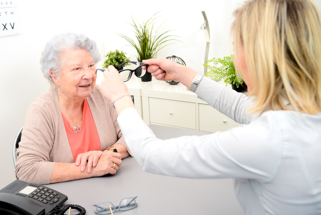 senior woman getting new prescription eye glasses